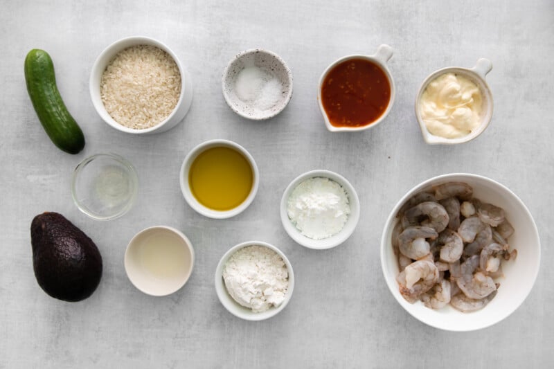 overhead view of ingredients for bang bang shrimp bowls in individual bowls.