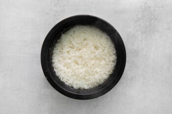 cooked rice in a black pot.
