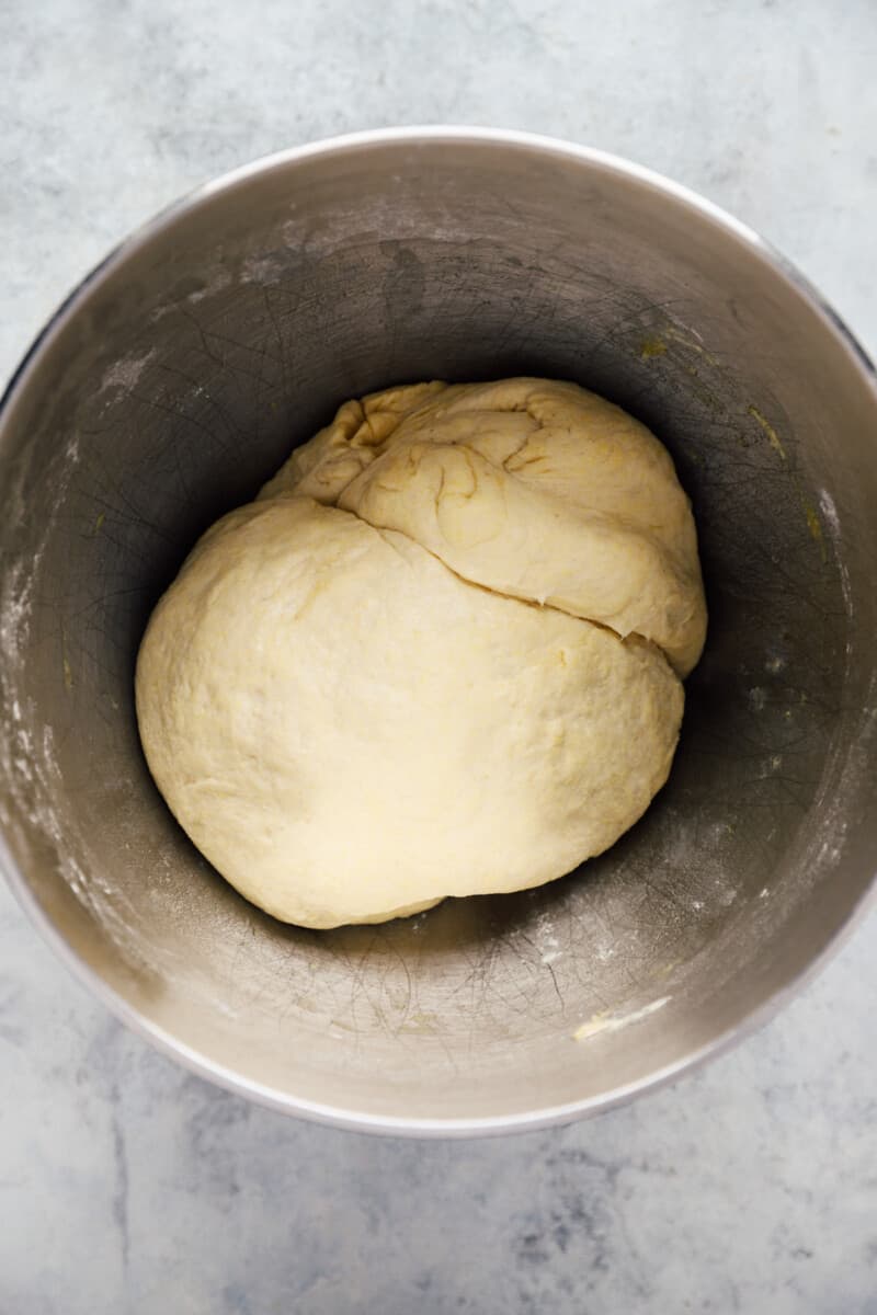 Chicago deep dish pizza dough in a stainless mixing bowl.