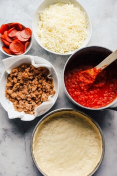 overhead view of ingredients for chicago deep dish pizza.