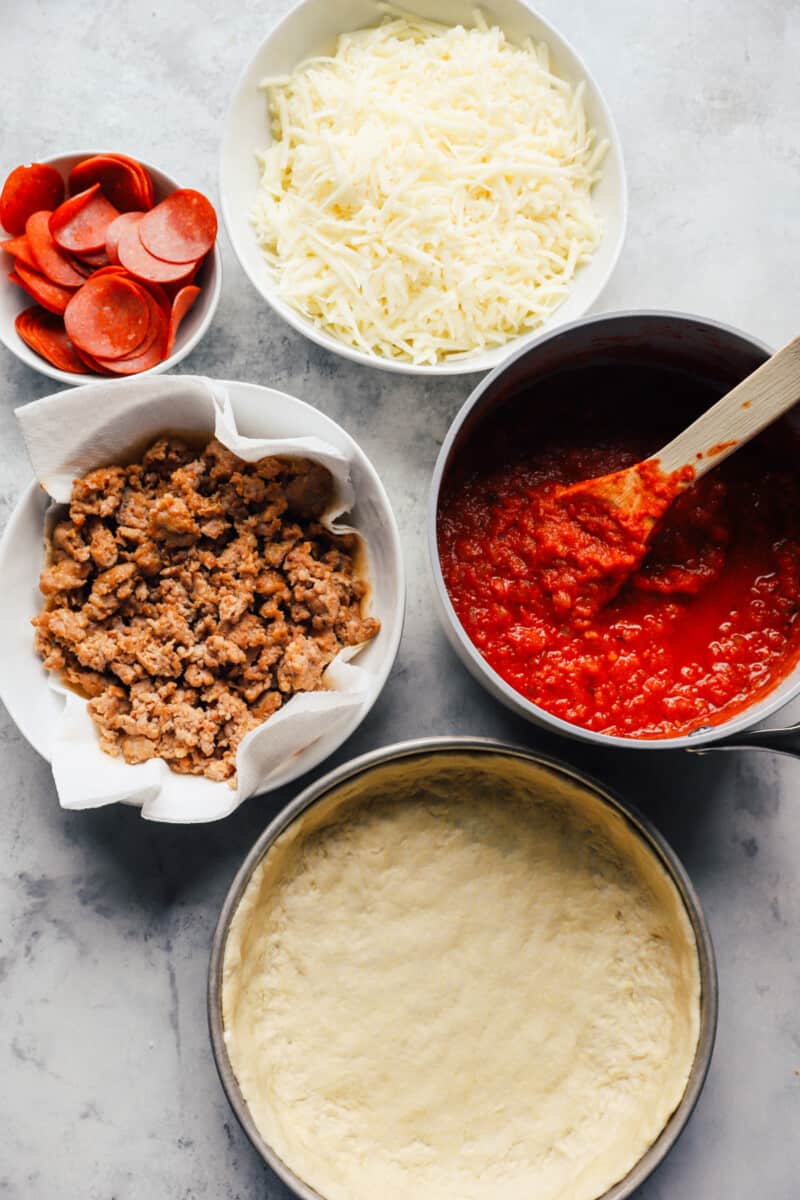 Overhead view of ingredients for Chicago deep dish pizza.