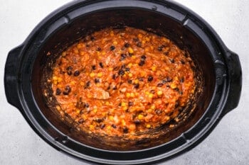 cooked crockpot chicken burrito filling in a crockpot.