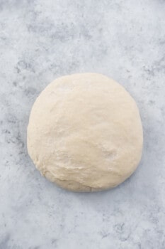 cronut dough on a marble counter.