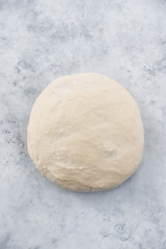 cronut dough on a marble counter.