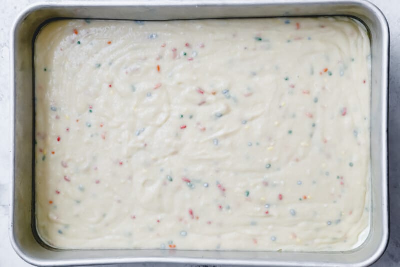 funfetti cake batter in a rectangular cake pan.