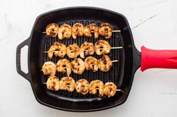 skewers of grilled shrimp on a grill pan