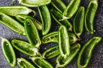 jalapeños cut in half with seeds removed