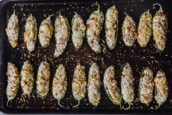 jalapeño poppers lined up on a baking sheet