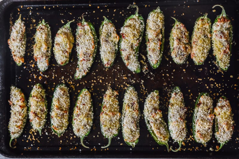 jalapeño poppers lined up on a baking sheet