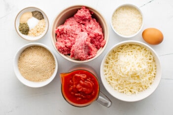 overhead view of ingredients for meatball casserole in individual bowls.