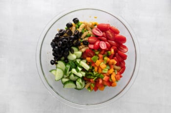 vegetables for veggie pasta salad in a glass bowl.