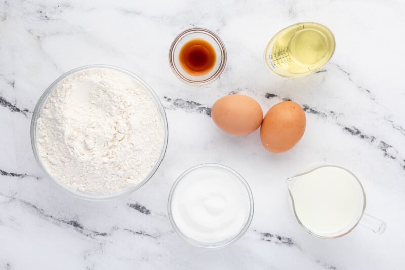 overhead view of ingredients for blueberry pancake muffins in individual bowls.