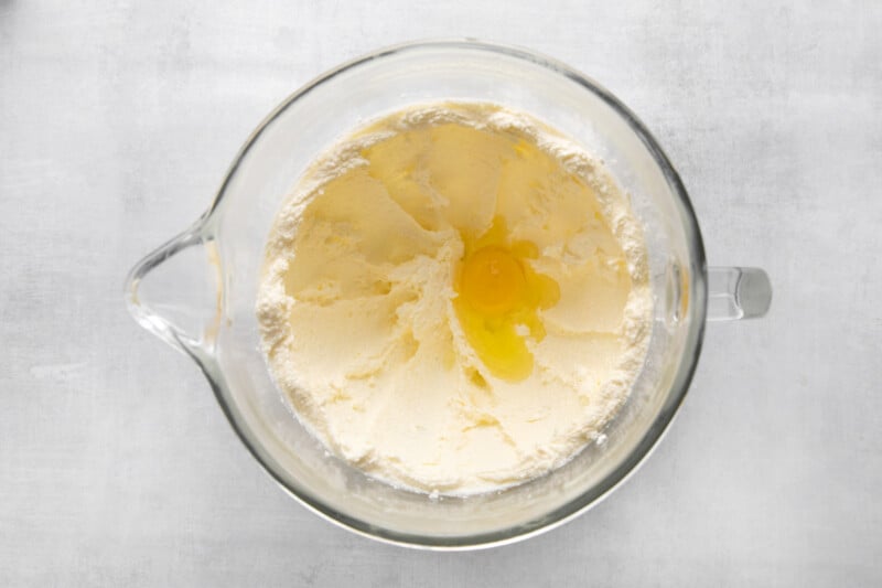 butter in a glass bowl on a white background.