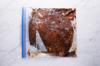 flank steak marinating in a ziplock bag.
