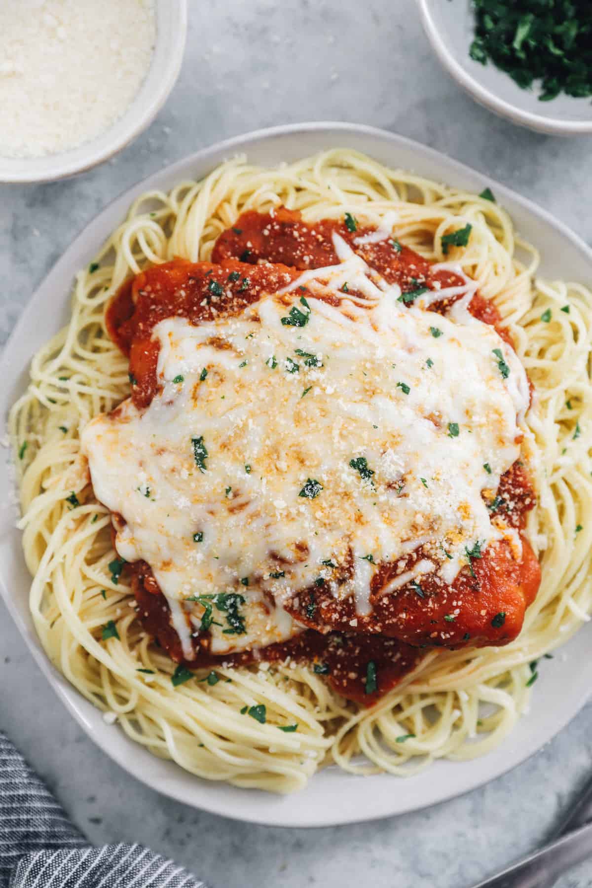 instant pot chicken parmesan with spaghetti on a white plate.