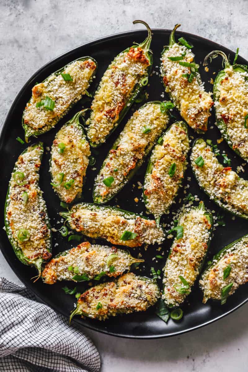 a skillet full of stuffed jalapeño poppers