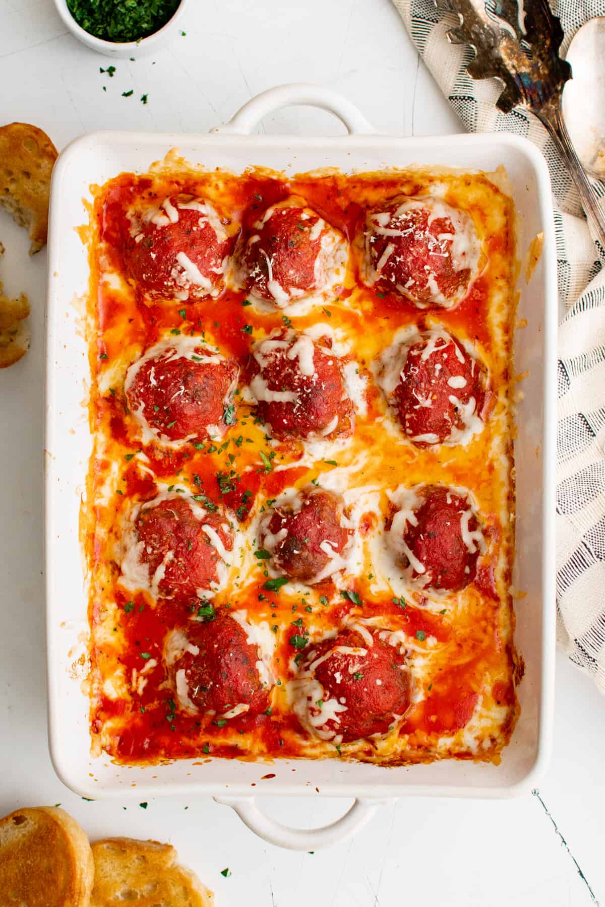 overhead view of meatball casserole in a white baking pan.