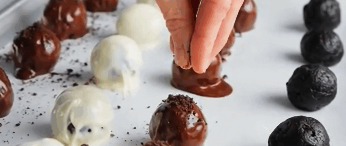 Sprinkling Oreo cookie crumbs over the Oreo balls. 
