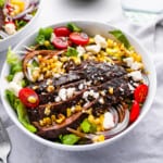 steak salad in a white bowl.