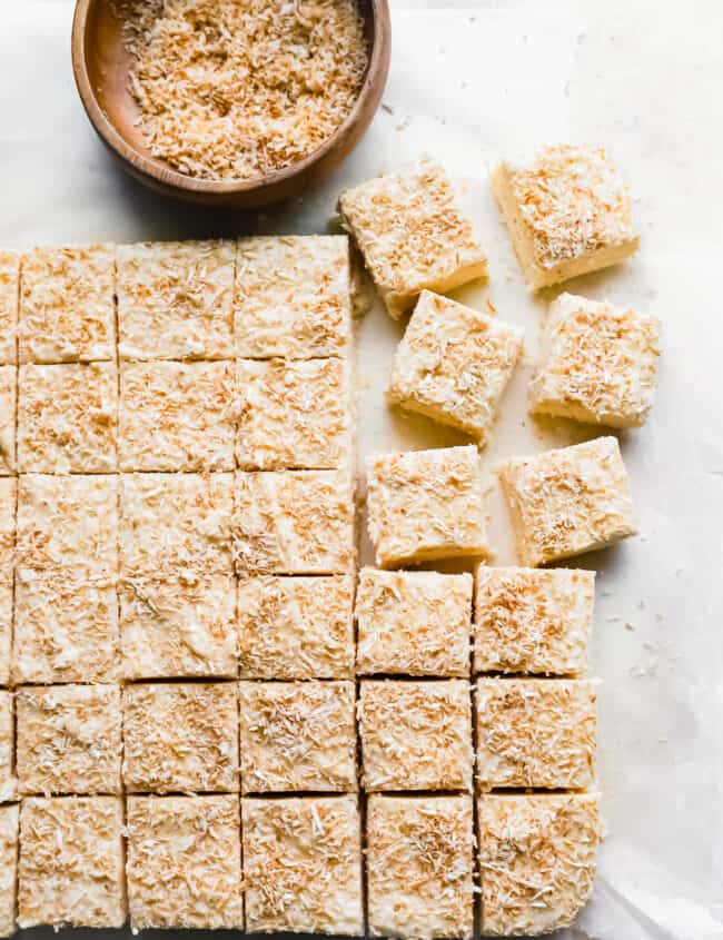 cut coconut fudge on a white table.