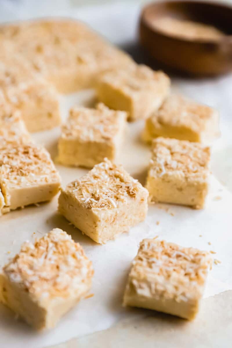pieces of coconut fudge on a white table.