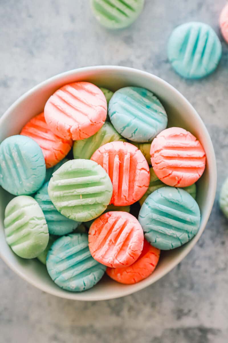 overhead view of cream cheese mints in a white bowl.