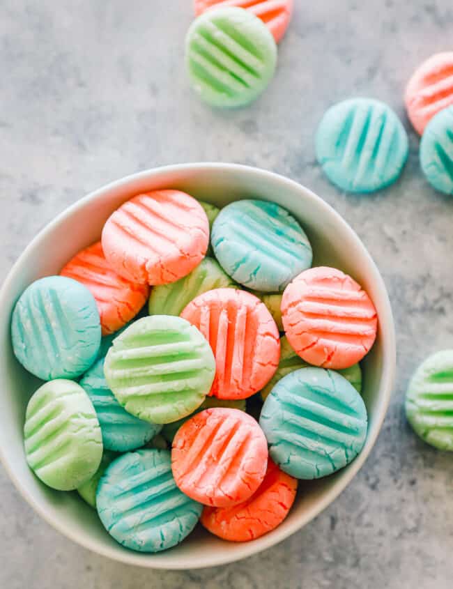 overhead view of cream cheese mints in a white bowl.