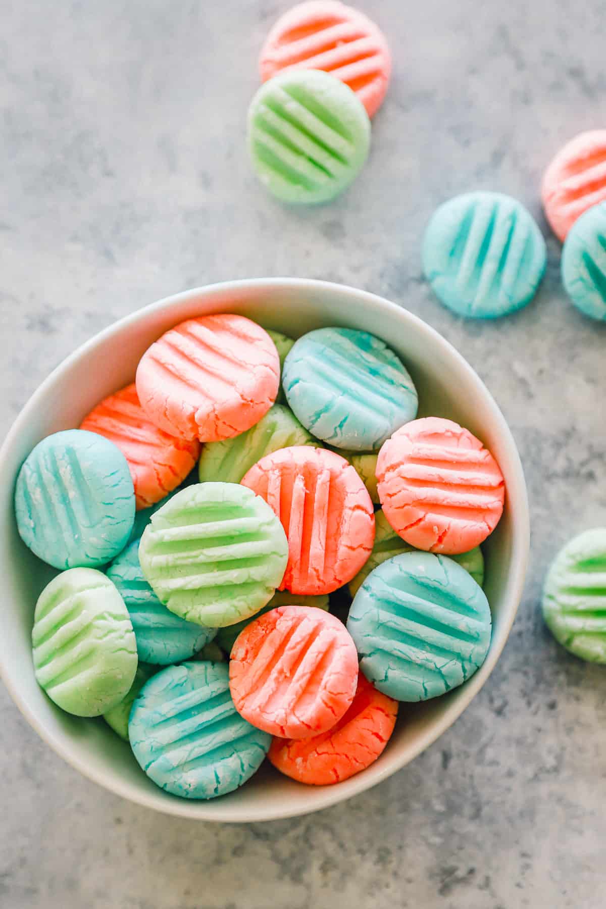 overhead view of cream cheese mints in a white bowl.