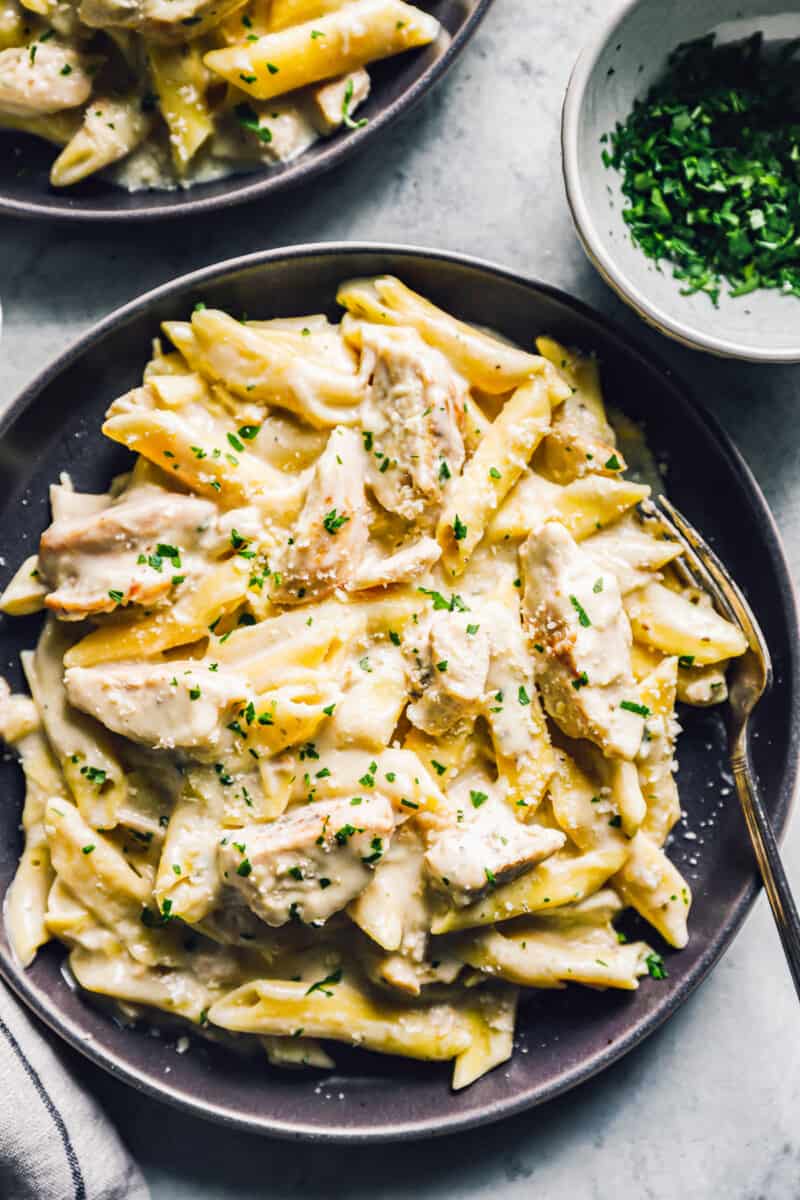 crockpot chicken alfredo on black plates