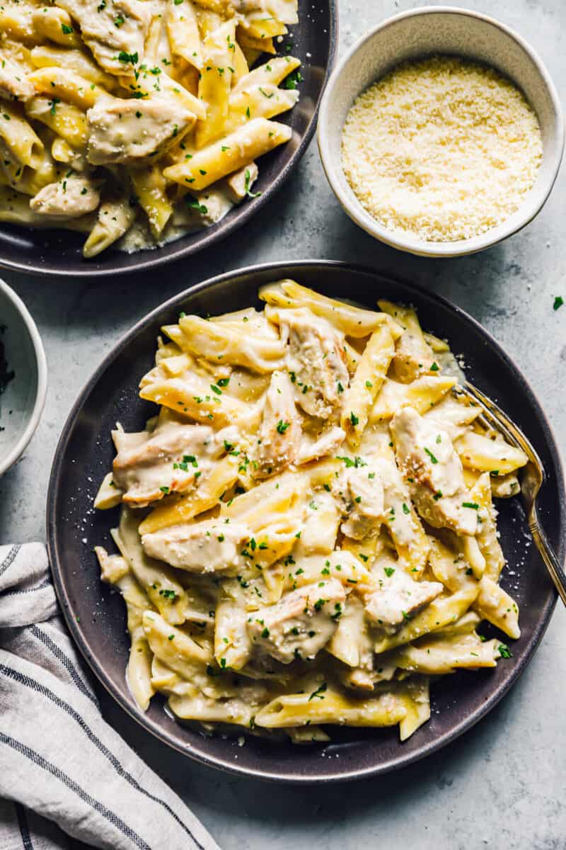 crockpot chicken alfredo on black plates