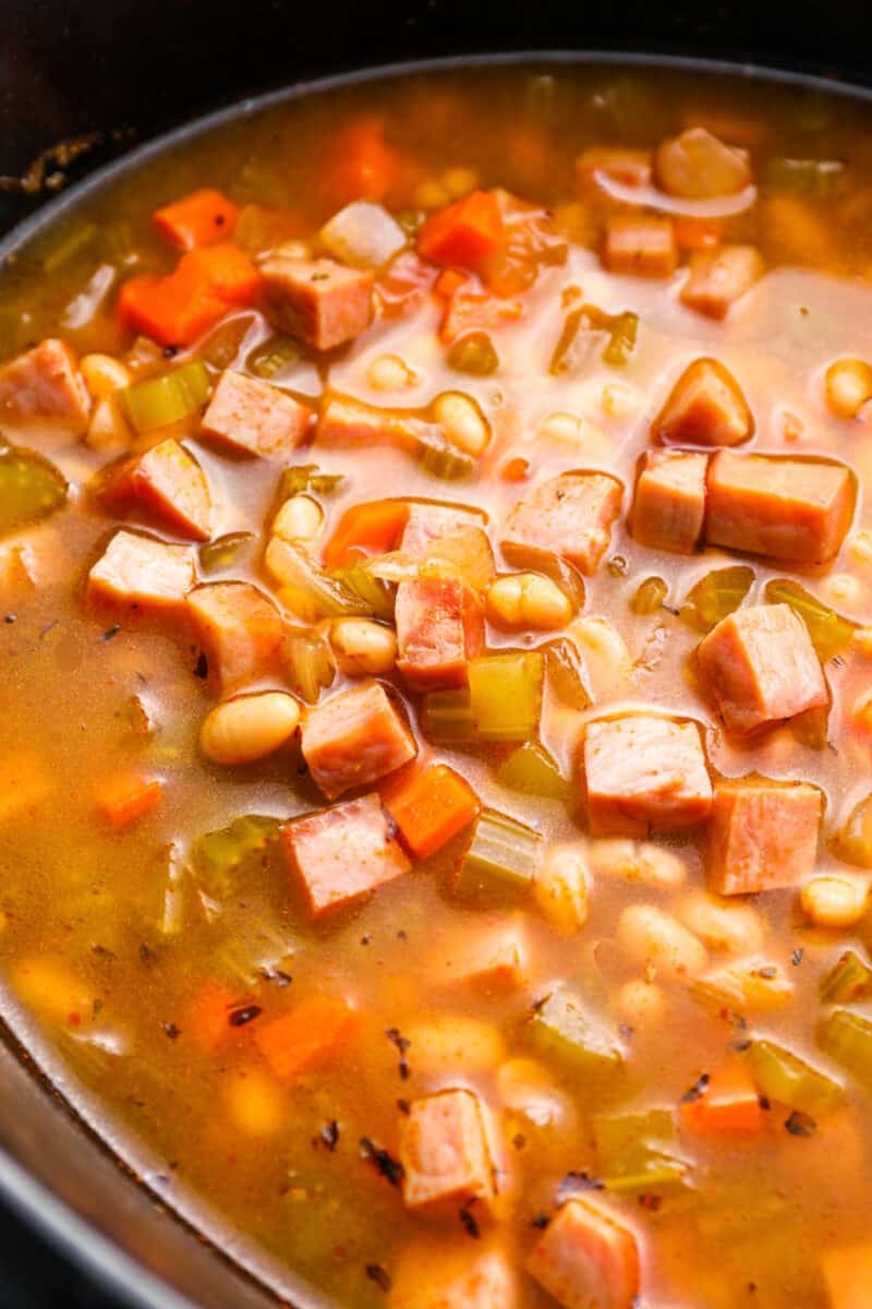 close up of crockpot ham and bean soup in a crockpot.