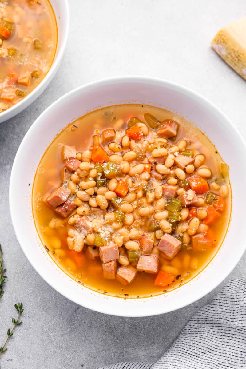 crockpot ham and bean soup in a white bowl.