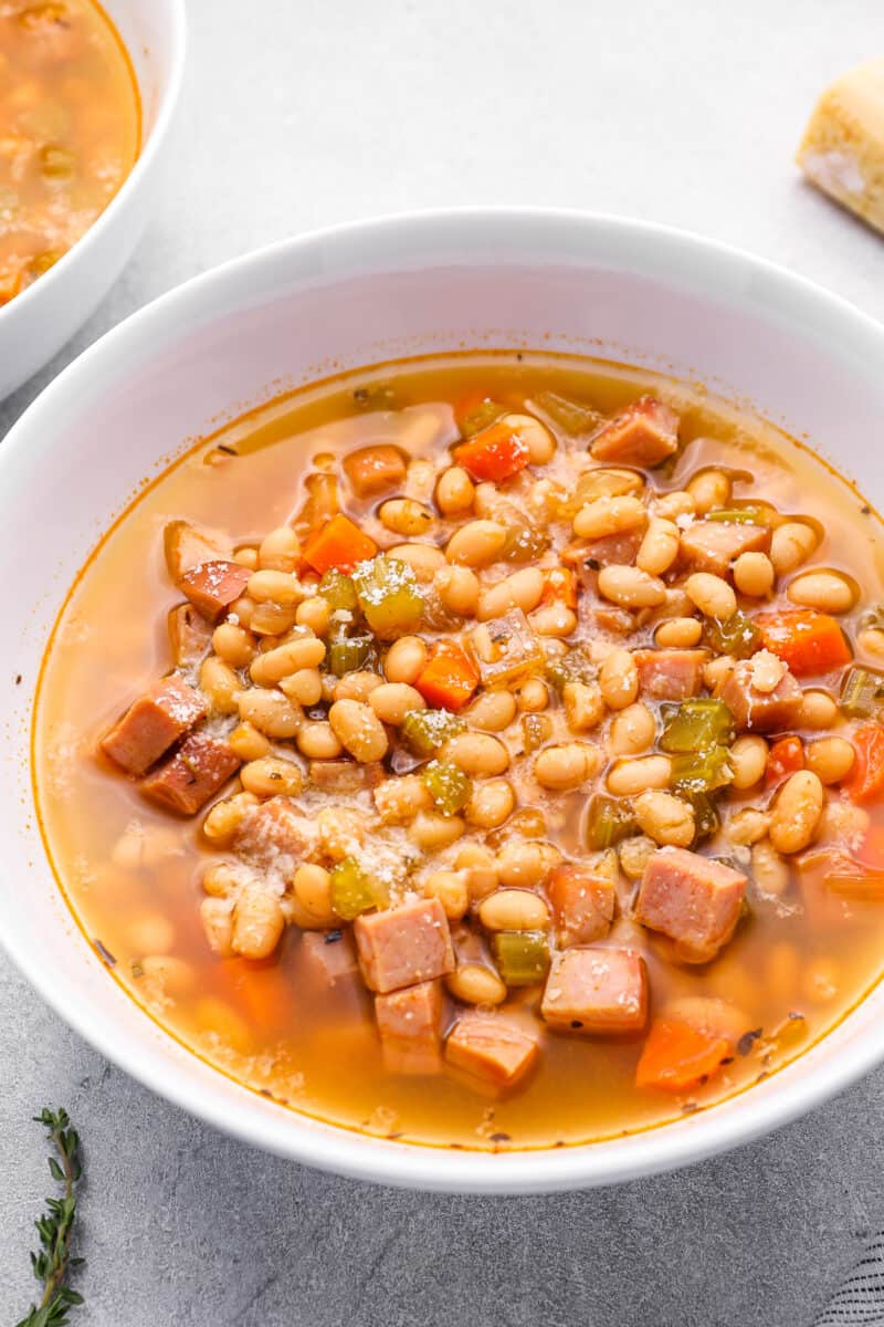 crockpot ham and bean soup in a white bowl.
