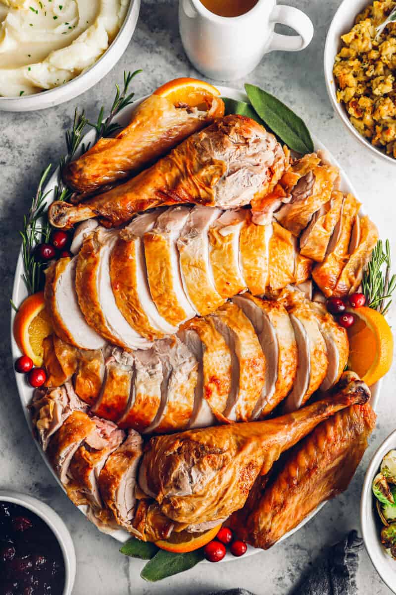 sliced deep fried turkey on a white serving plate.