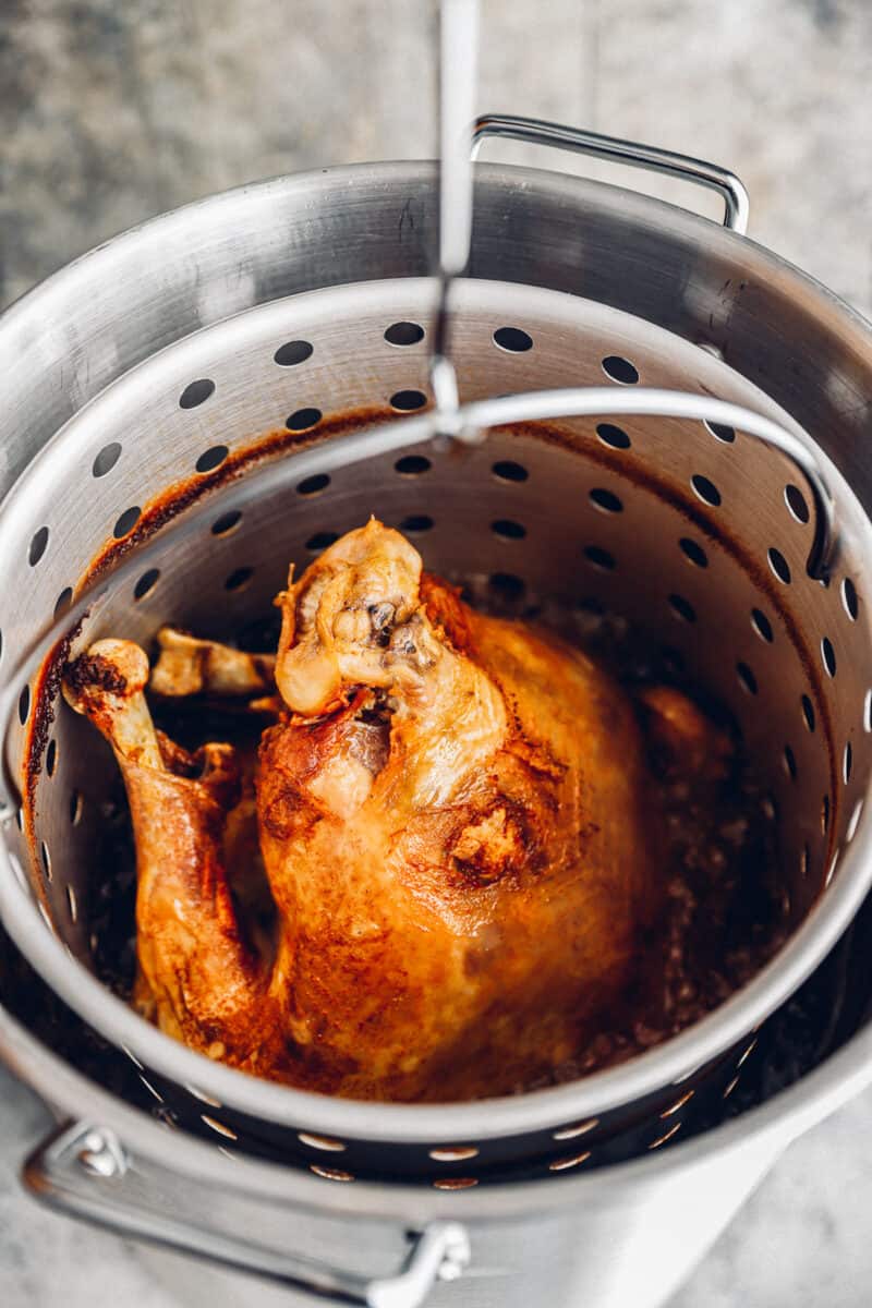 deep fried turkey in a strainer basket.
