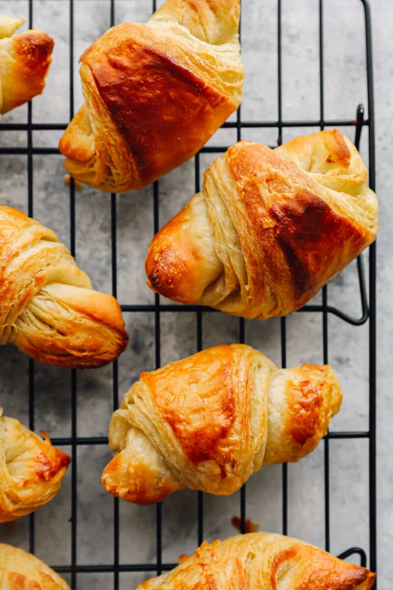 overhead view of croissants on a wire rack.