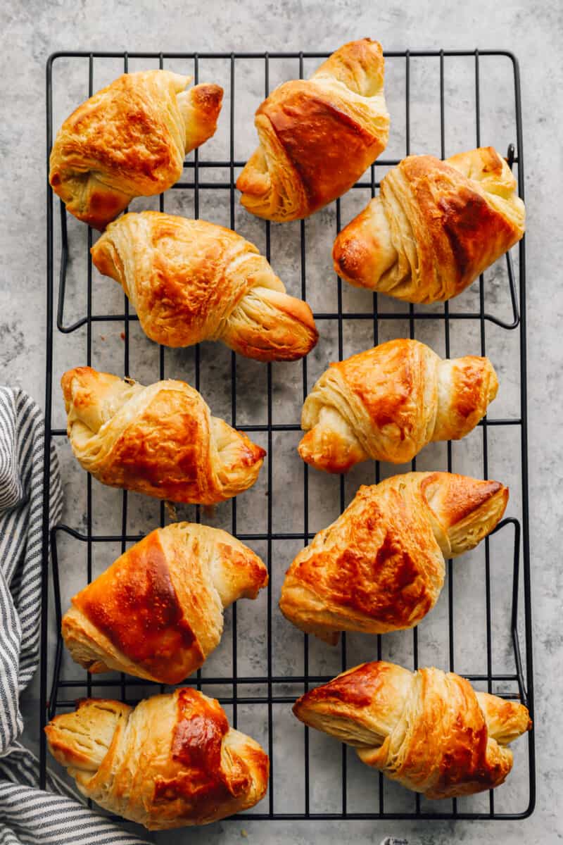 overhead view of 10 croissants on a wire rack.