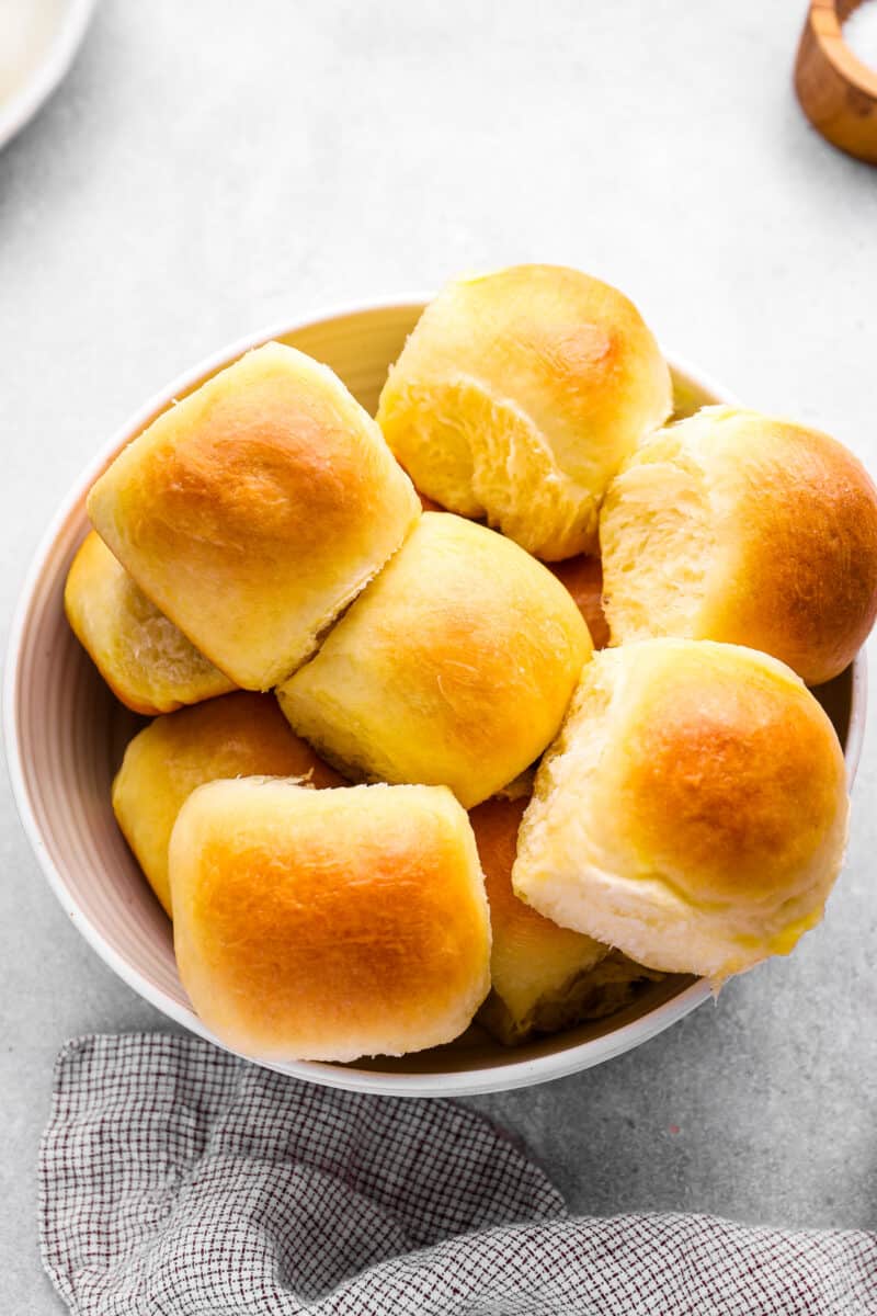 dinner rolls in a white bowl.