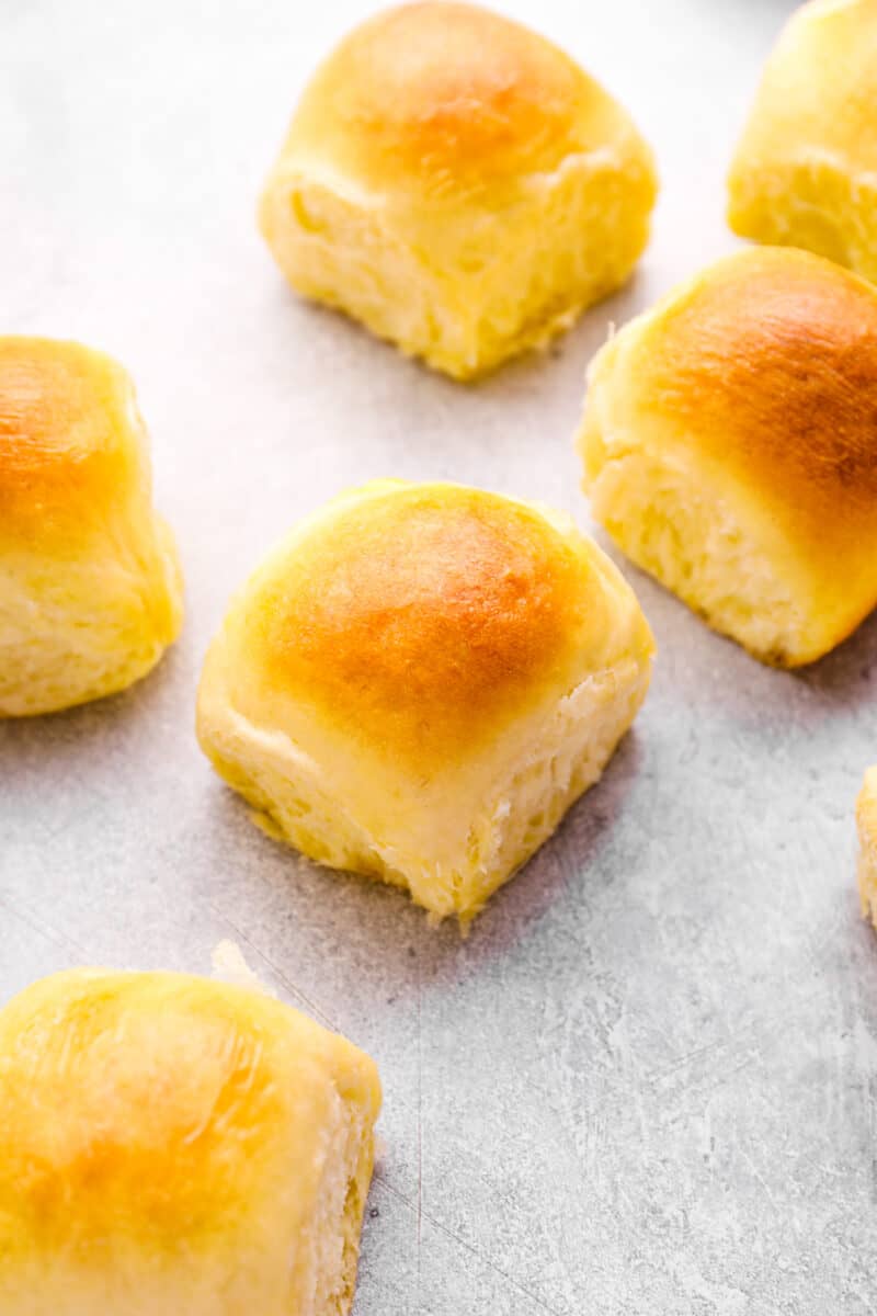 dinner rolls scattered on a tabletop.