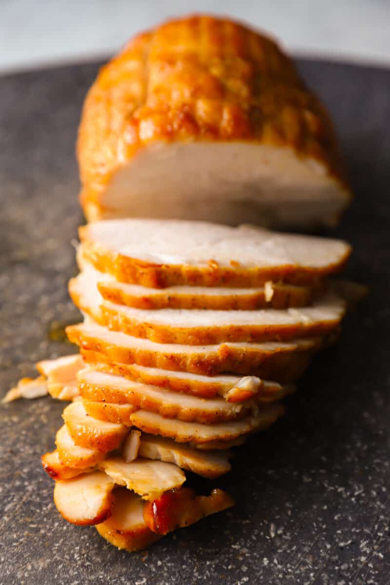 sliced honey baked turkey breast on a table.