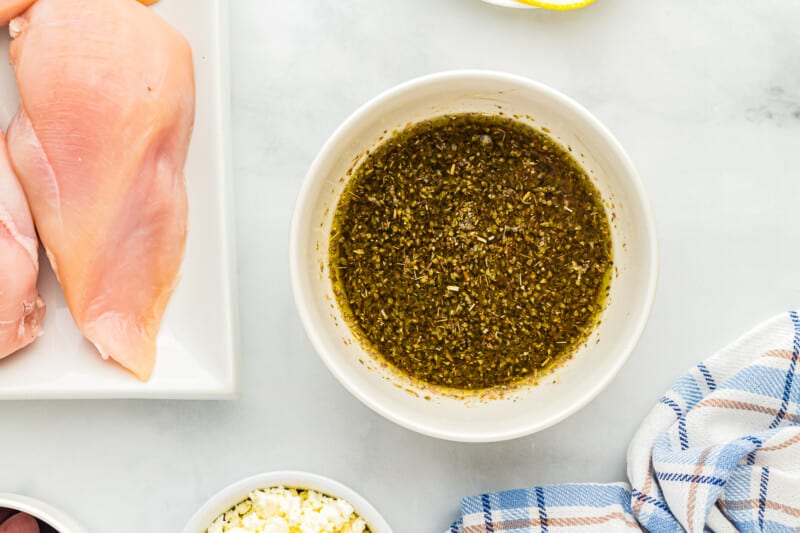 overhead view of greek marinade in a white bowl.