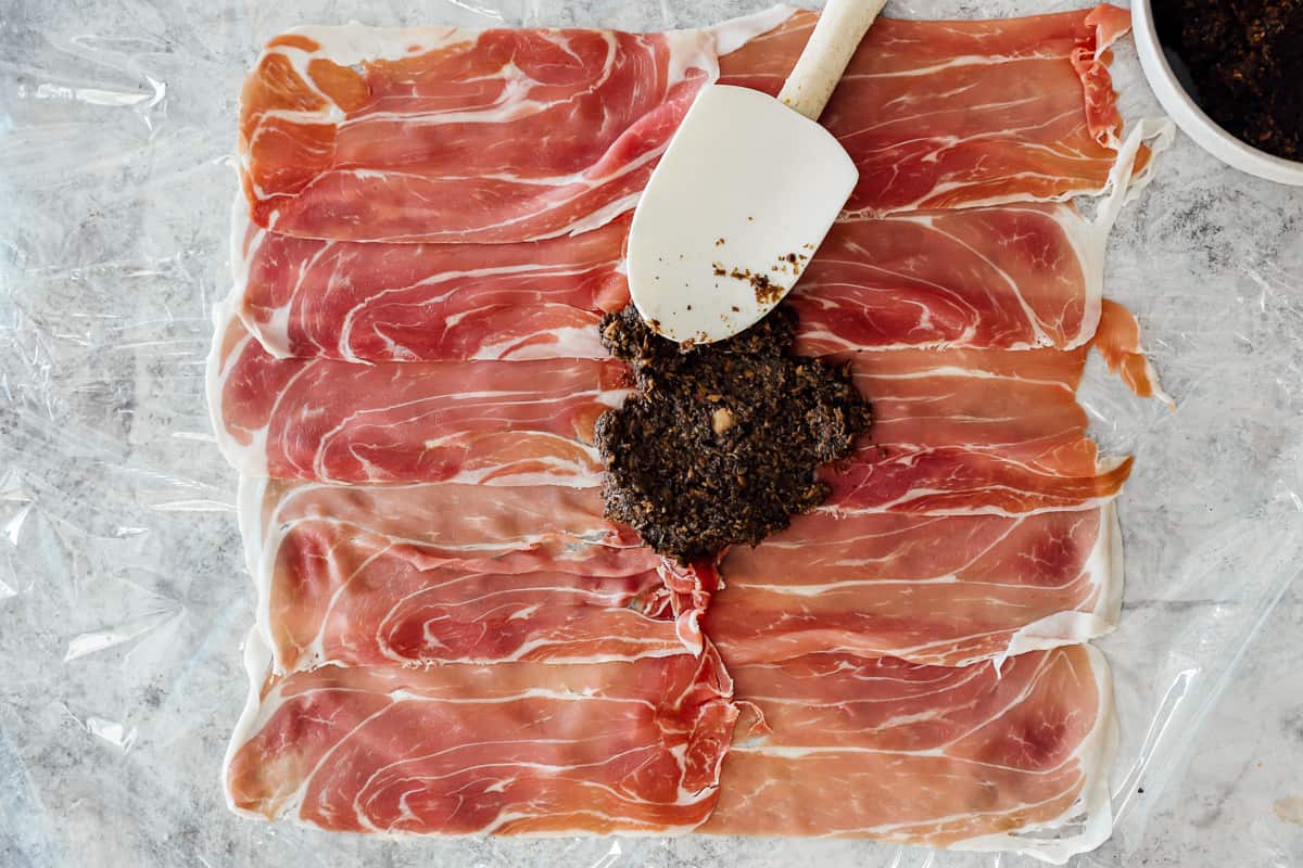mushroom mixture spread over slices of proscuitto.