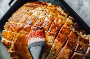 brown sugar glaze brushed over ham in a roasting pan.