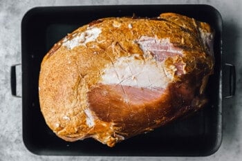 diamond sliced ham in a roasting pan.