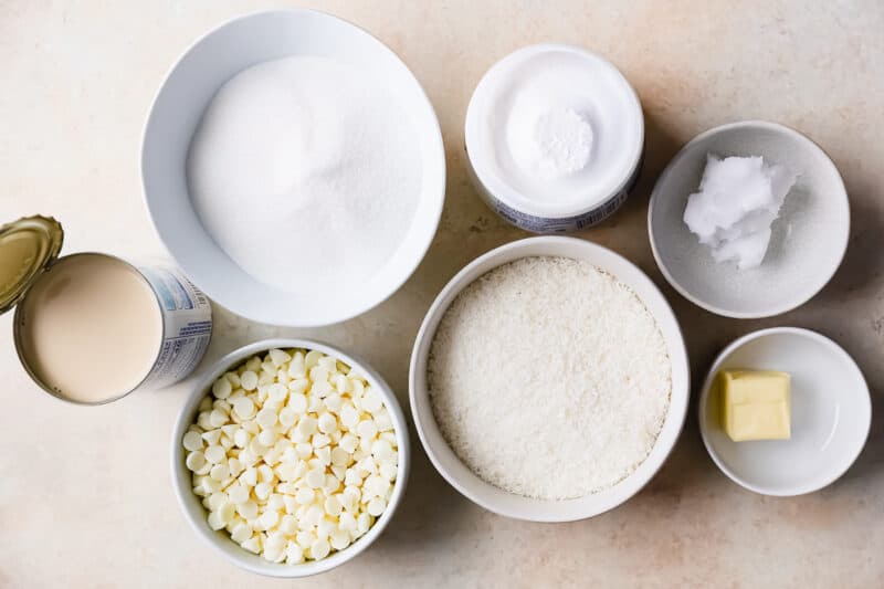 overhead ingredients for coconut fudge in individual bowls.