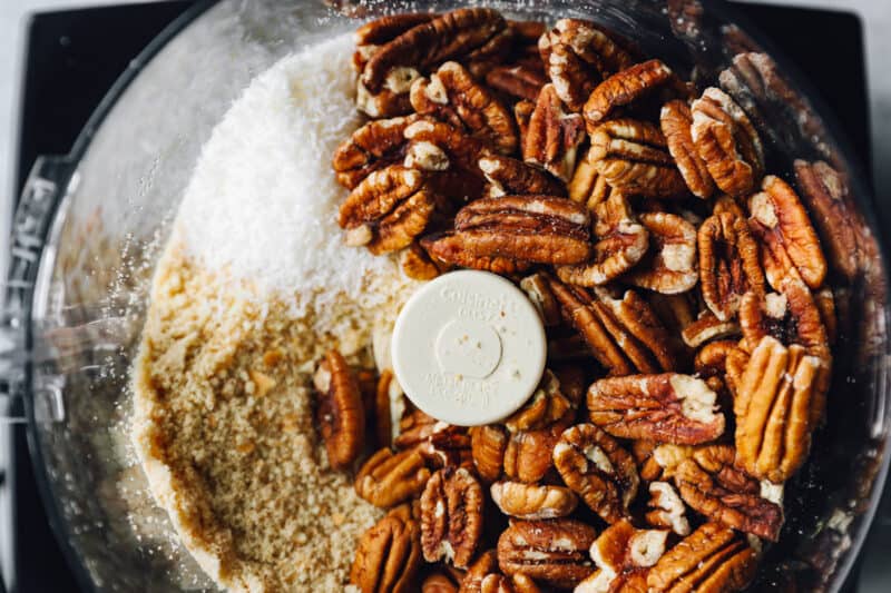 pecans added to a food processor.