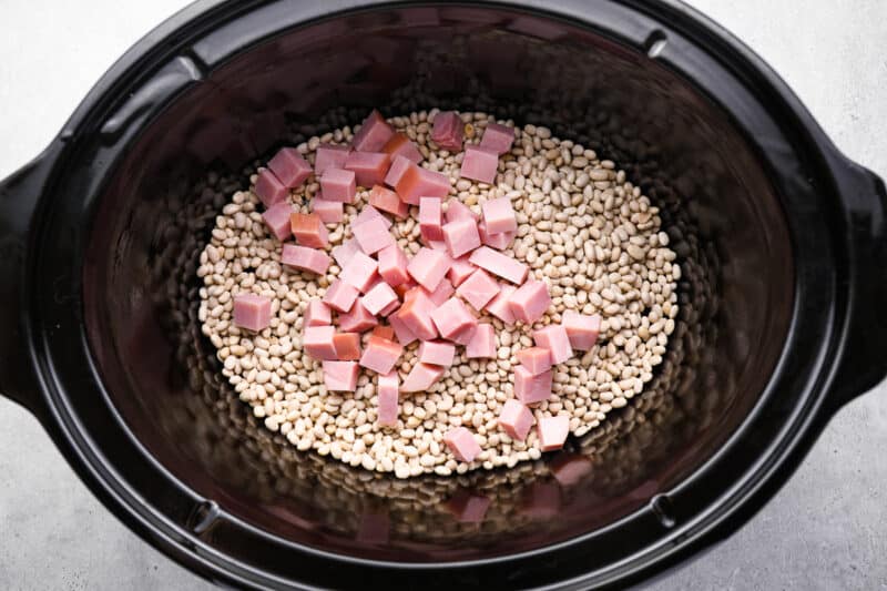 ham added to dried beans in a crockpot.
