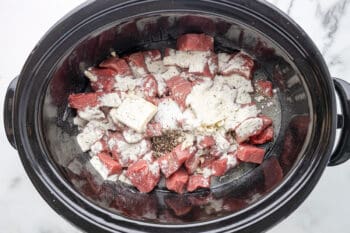 ranch seasoning, salt, and pepper on top of cubed sirloin in a crockpot.