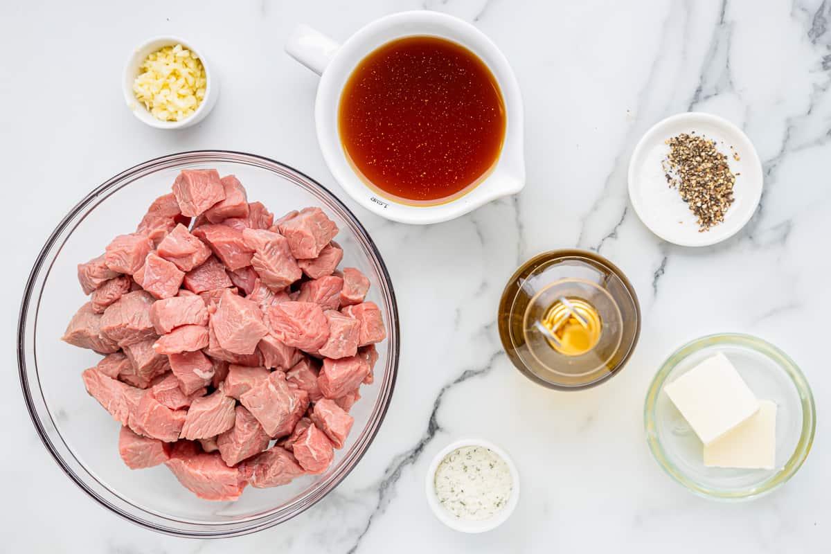 overhead view of ingredients for crockpot steak bites in individual bowls.