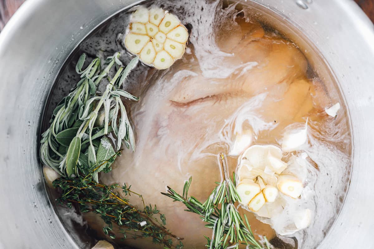 raw whole turkey in a pot of brine.